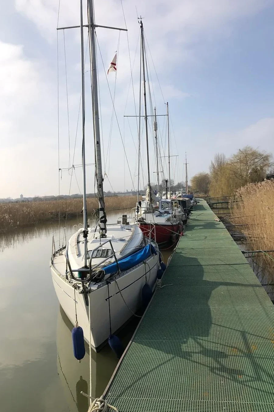 Sailing boats beside the pontoon at Sandwich Marina