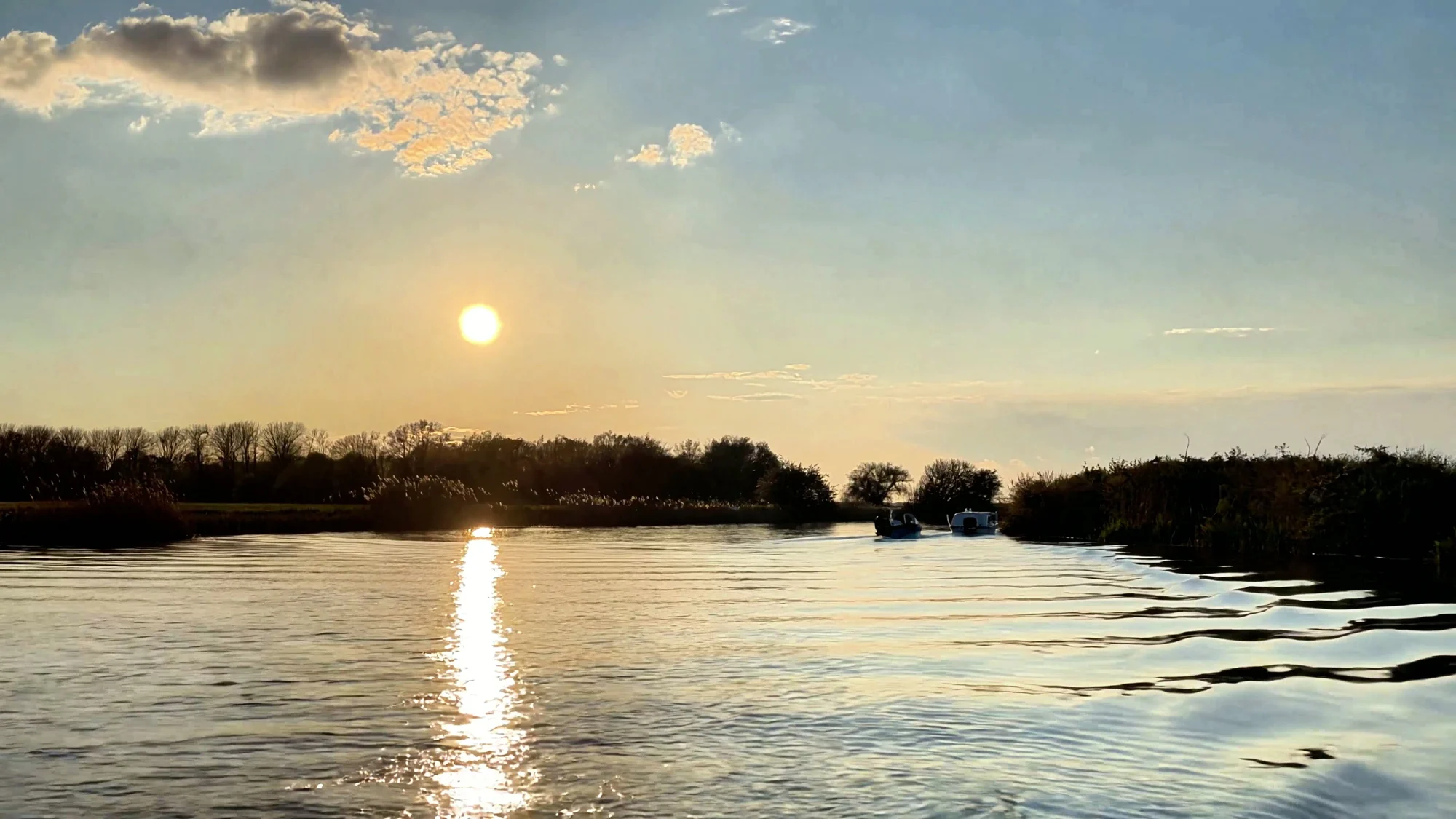 Warm evening sunlight reflecting across the River Stour